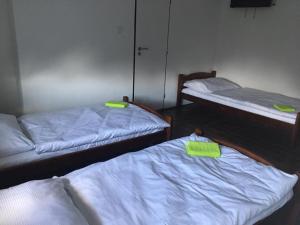 two beds in a room with green sticky notes on them at Penzión Brabčák in Vratimov