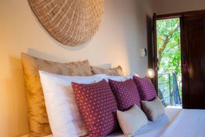 Кровать или кровати в номере Rambutan Resort – Siem Reap