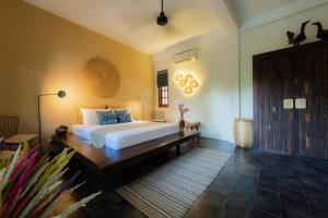 Кровать или кровати в номере Rambutan Resort – Siem Reap