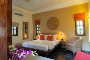 Кровать или кровати в номере Rambutan Resort – Siem Reap