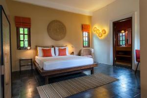 Кровать или кровати в номере Rambutan Resort – Siem Reap