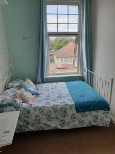 a bedroom with a bed and a window at Haven in Herne Bay