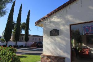 a building with a clock on the side of it at Valley Hotel in Rosemead
