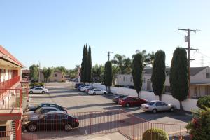 a parking lot with cars parked in a parking lot at Valley Hotel in Rosemead