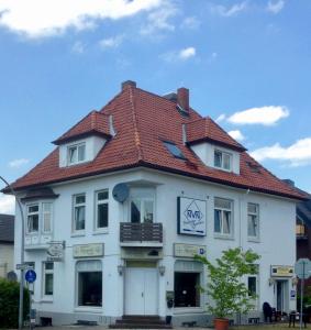 a white building with a red roof at Pension Akropolis in Rellingen