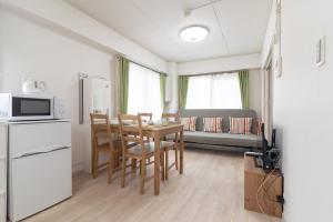 a kitchen and dining room with a table and chairs at Uhome Iriya Apartment in Tokyo