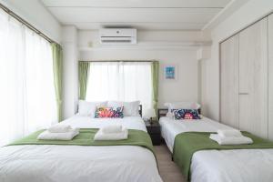 Postel nebo postele na pokoji v ubytování Uhome Iriya Apartment
