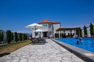 a house with a swimming pool in front of a house at Ossanna Hotel in Yerevan