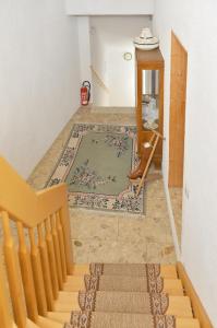a room with a staircase and a rug on the floor at Pension Damköhler Thale OT Westerhausen in Thale