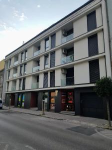 a large white building on the side of a street at Holiday Apartman with Free Parking in Győr