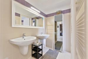 a bathroom with two sinks and a mirror at CASA AGATA in Vicenza