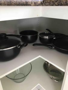 a group of pots and pans sitting on a counter at Cozy 3BR Townhouse in Liverpool CBD with parking in Liverpool