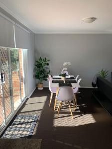 a dining room with a table and chairs at Cozy 3BR Townhouse in Liverpool CBD with parking in Liverpool