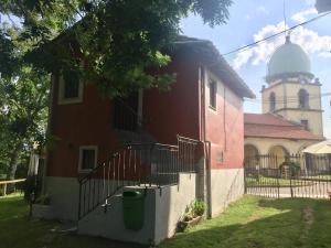 a building with a church with a clock tower at La casina del Indiano in Malleza