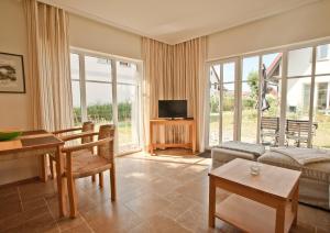 a living room with a couch and a table at Ferienhäuser Südwind in Hiddensee