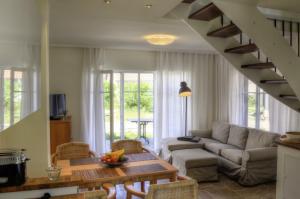 a living room with a couch and a table at Ferienhäuser Südwind in Hiddensee