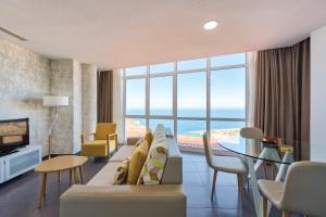 a living room with a couch and a view of the ocean at Holiday Club Vista Amadores in Amadores