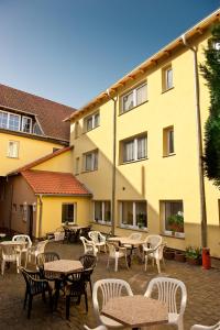 a courtyard with tables and chairs in front of a building at Pension Damköhler Thale OT Westerhausen in Thale