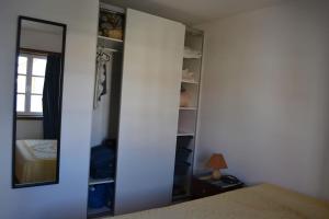 a bedroom with a mirror and a bed at Our Sunset Spot in Zambujeira do Mar