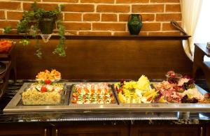 a buffet with many different types of food on a tray at Hotel Polonia in Kraków