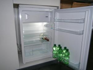 an open refrigerator with soda bottles in it at Wohnen im ehemaligen Kaminstudio mit Klimaanlage in Lutherstadt Wittenberg