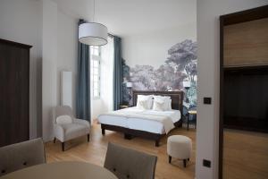 a bedroom with a bed and a table and chairs at College des Doctrinaires in Lectoure