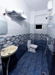 a bathroom with a toilet and a sink at Sree Service apartments in Tirupati