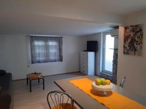a kitchen and living room with a table with fruit on it at grabrova cove in Novi Vinodolski +18 photos