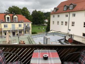 a balcony with a view of a house and a patio at Ferienwohnung Mentes in Füssen