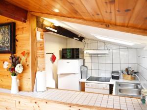 a kitchen with a refrigerator and a sink at Vintage Chalet in Sougn Remouchamps near Forest in Aywaille