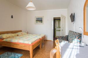 a bedroom with a bed and a couch and a table at La Caquerelle in Col des Rangiers