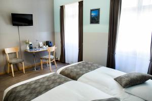 Cama o camas de una habitación en Hôtel Bel'Espérance