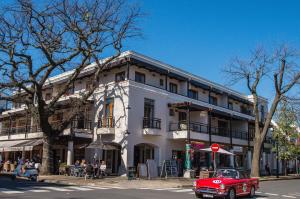 a red car parked in front of a white building at Casa Bella Stellenbosch - Jan Cats No 4 in Stellenbosch