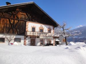 a large building with snow on the ground at Tuschnhof in Rinn