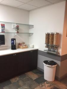 a kitchen with a counter and a trash can at Days Inn by Wyndham Hinton in Hinton