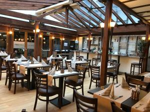 a restaurant with tables and chairs and a bar at Landhaus Pohlhof in Cologne +32 photos