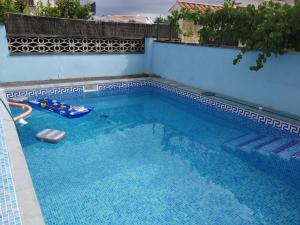 a swimming pool with blue water in a building at Cosy House Near Beach in Lloret de Mar