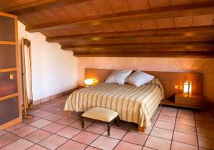 a bedroom with a bed and a chair in a room at Hotel Restaurante La Masieta in Creixell +25 photos