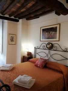 a bedroom with a bed with two towels on it at B&B Alle Due Porte in Siena