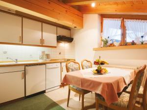 a kitchen with a table with a table cloth on it at Hotel Garni Ingeborg in Mittelberg