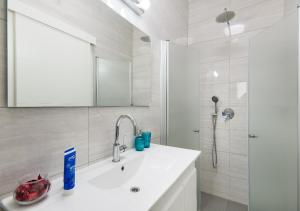 a bathroom with a sink and a mirror and a shower at Balfour sea view city center in Nahariyya +101 photos
