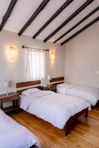 En eller flere senge i et værelse på Luna Rumi Hotel-Lodge Urubamba