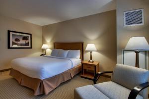 a hotel room with a bed and a chair at Hollywood Casino Bangor in Bangor