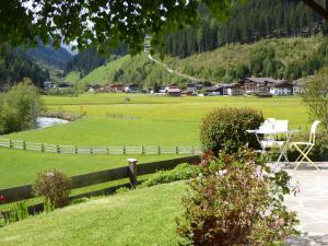 a park with a fence and a field with houses at Haus Mali in Neustift im Stubaital