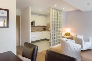 a kitchen and living room with white cabinets and chairs at Kelston South Dublin in Dublin