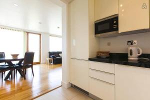 a kitchen and living room with a table and chairs at Grande Central in Dublin