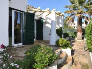 a house with a garden with a pergola at Tranquil Villa in Vilamoura with Private Swimming Pool in Vilamoura