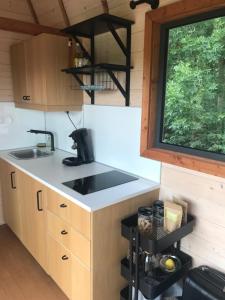 a kitchen with a sink and a counter top at TinyHouse on the prairie in Mehaigne