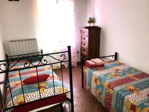 Postel nebo postele na pokoji v ubytování Agriturismo podere Casano