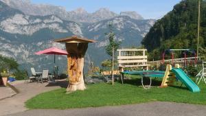 un parque infantil con una mesa y un árbol en Bellahof, en Flumserberg